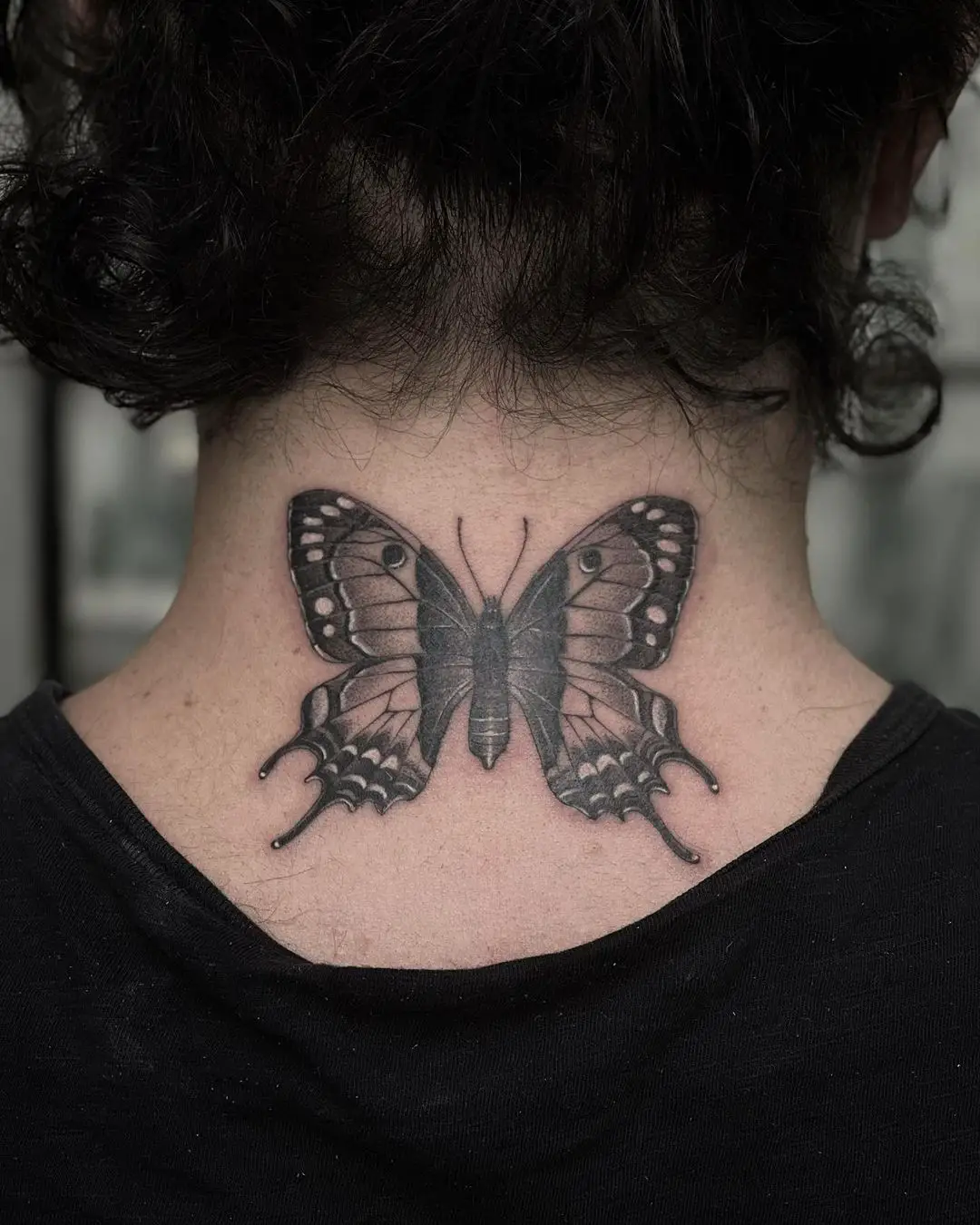 Large Blackwork Butterfly Tattoo on Back of Neck