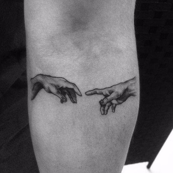 Small Michelangelo hands tattoo for men
