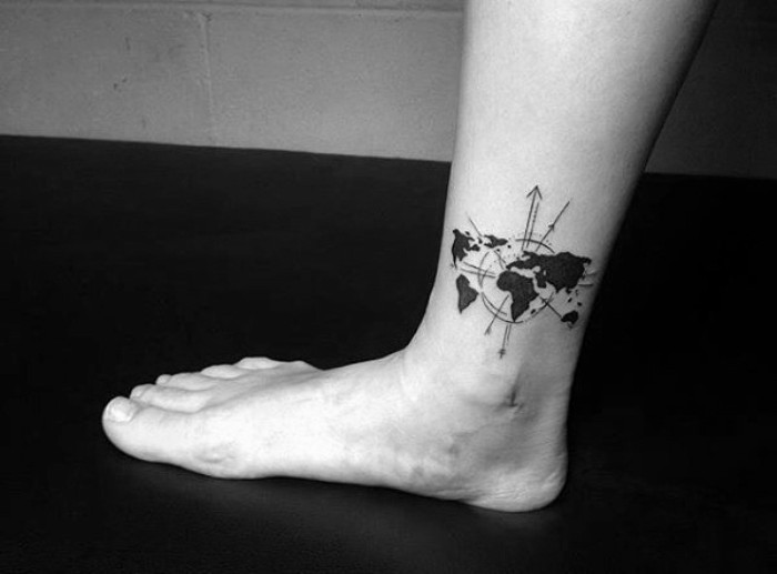 world-map-decorated-with-circles-and-arrows-tattooed-in-black-on-a-man-s-ankle-small-tattoos-with-meaning-travel-the-world