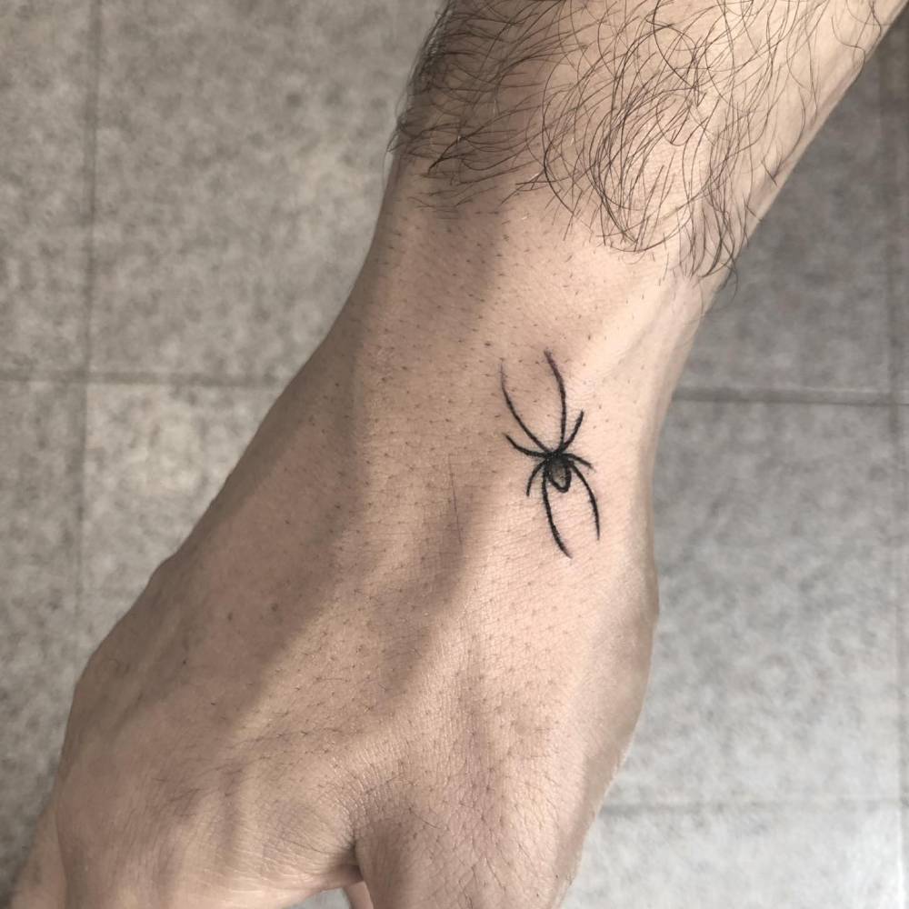 small spider tattoo on hand