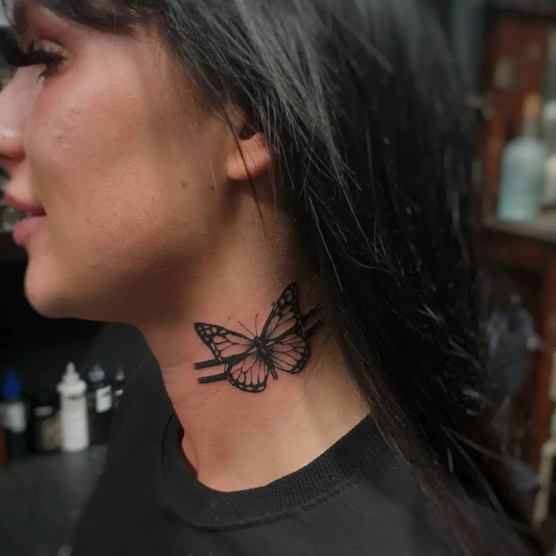 Blackwork Butterfly Tattoo on Side of Woman’s Neck