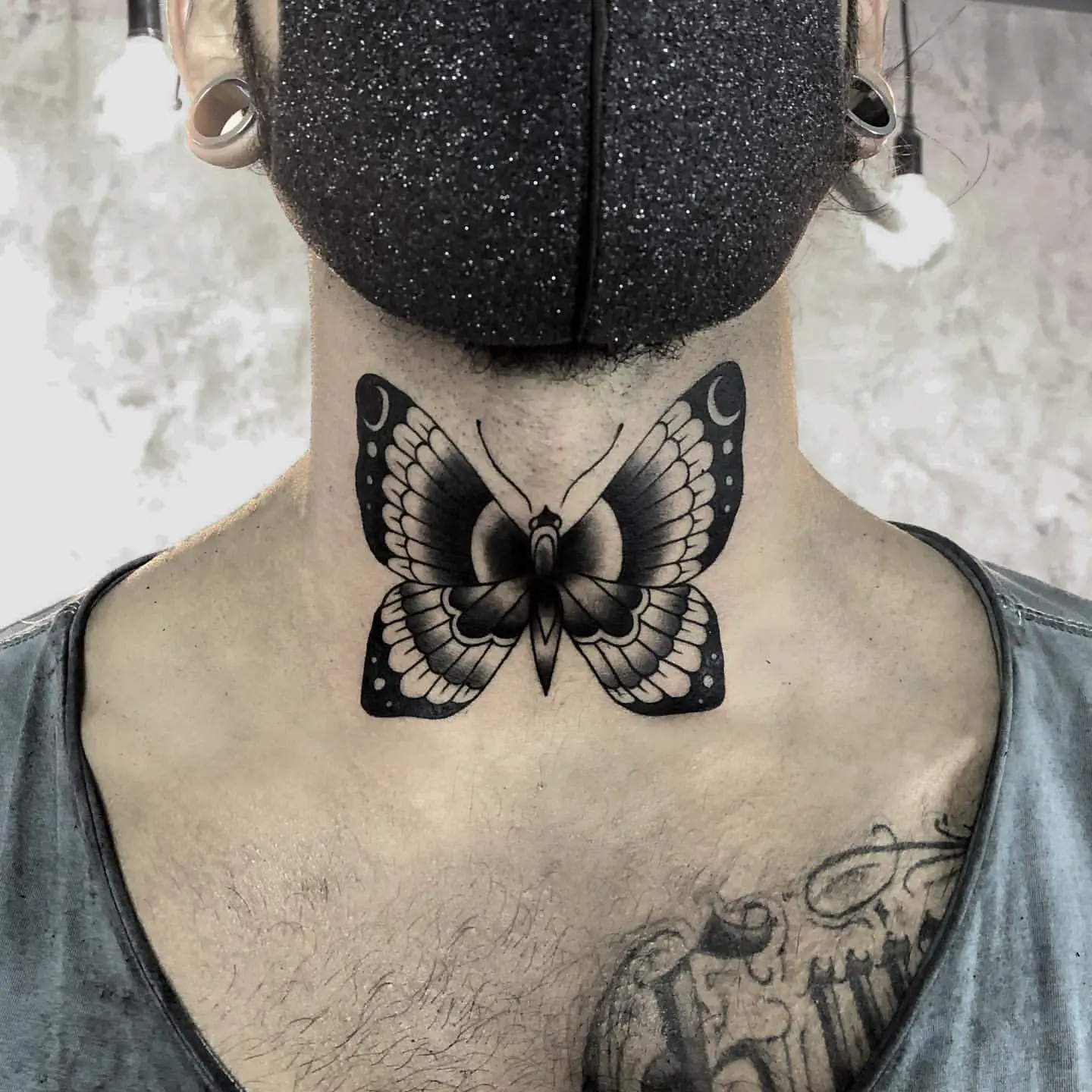Dramatic Old School Butterfly Tattoo on Man’s Neck