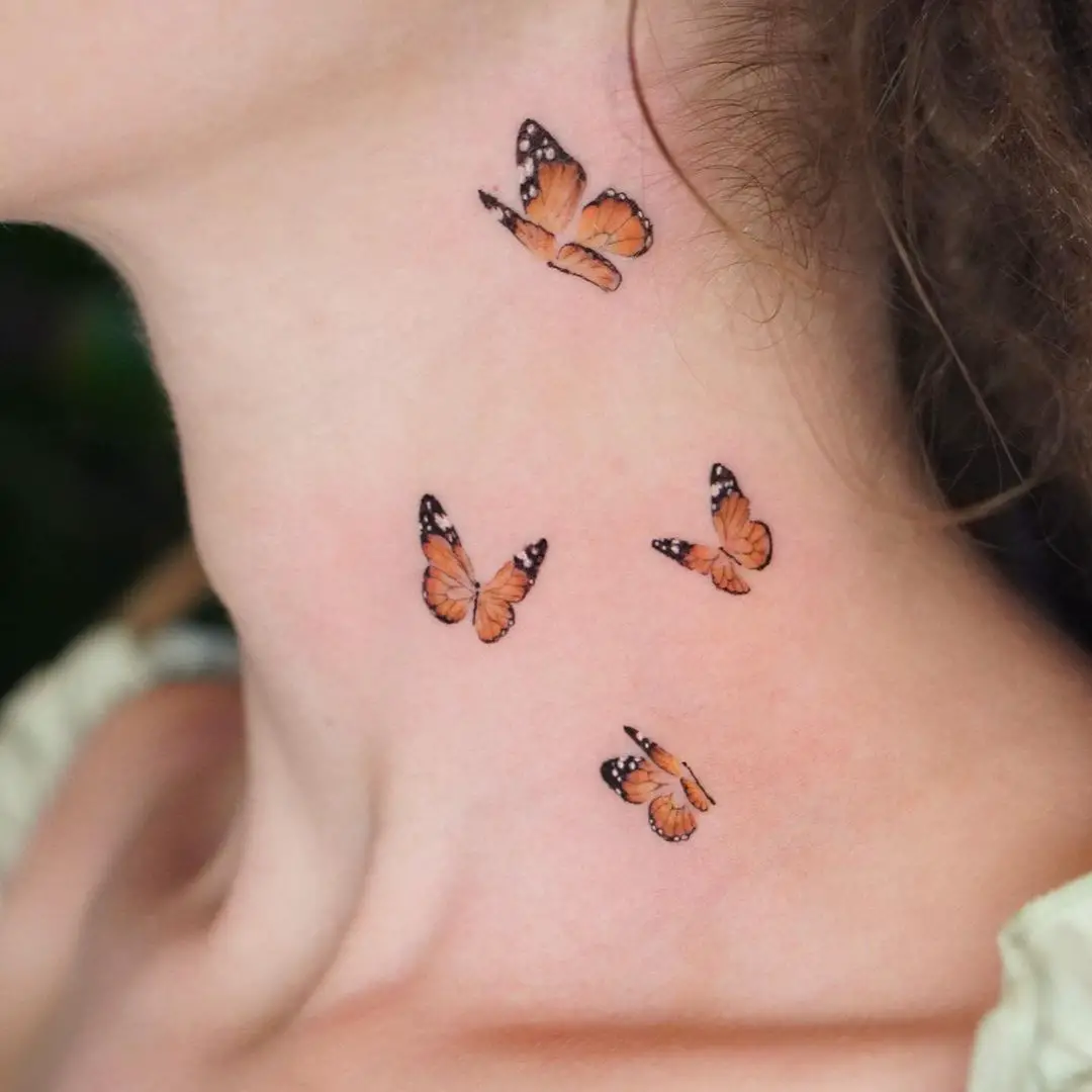 Four Little Butterfly Tattoos on Side of Neck
