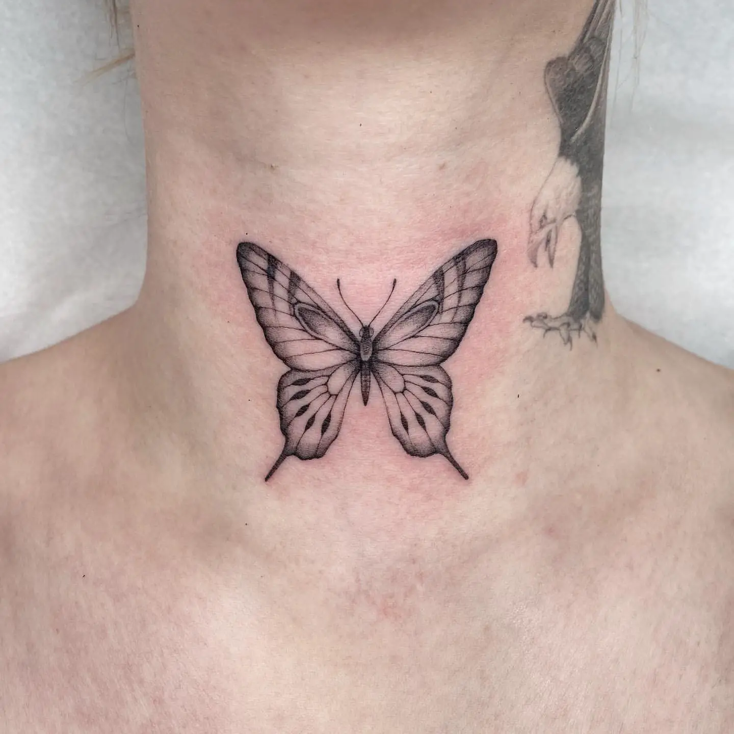 Large Black and Gray Butterfly Tattoo on Front of Neck