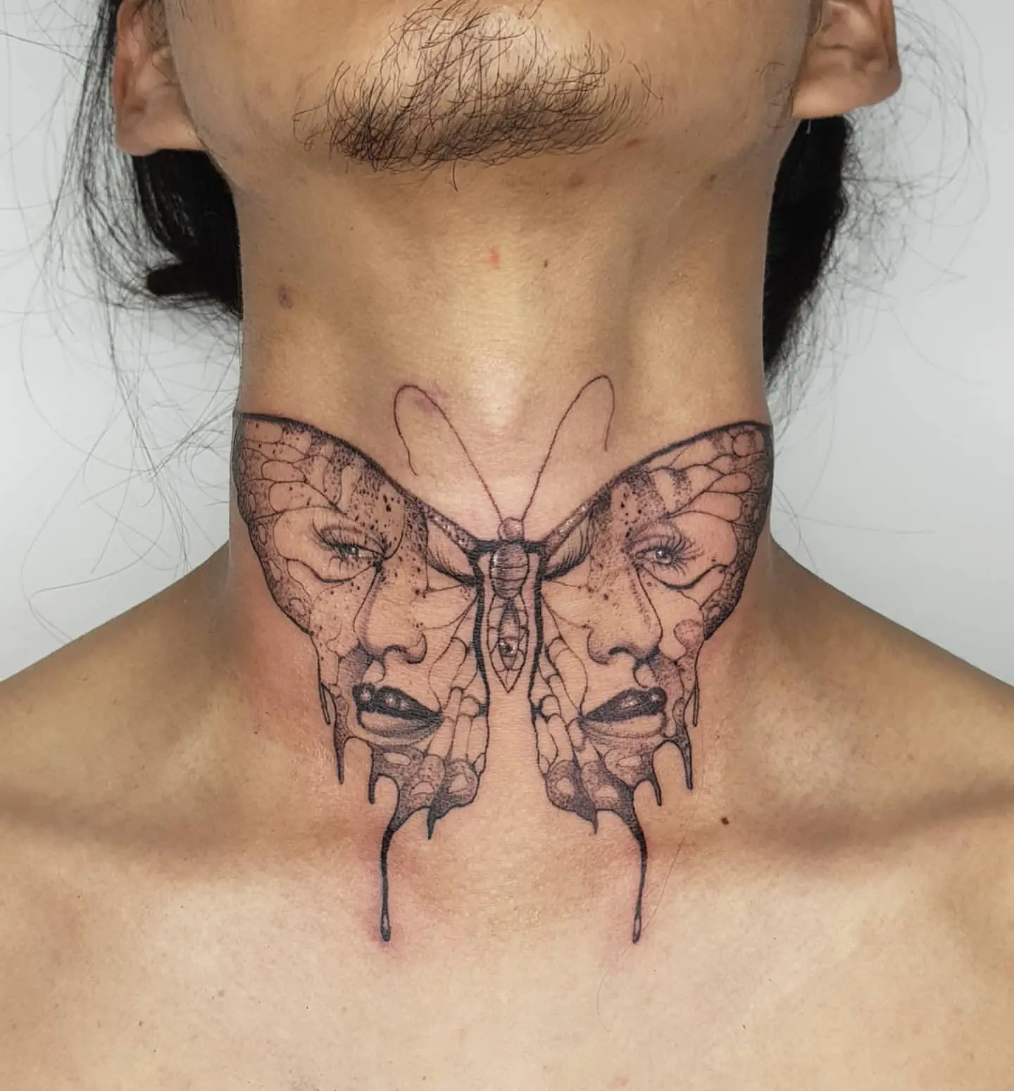 Large Butterfly Tattoo on Man’s Neck